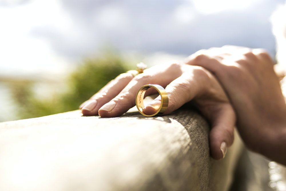 a woman holding her wedding band