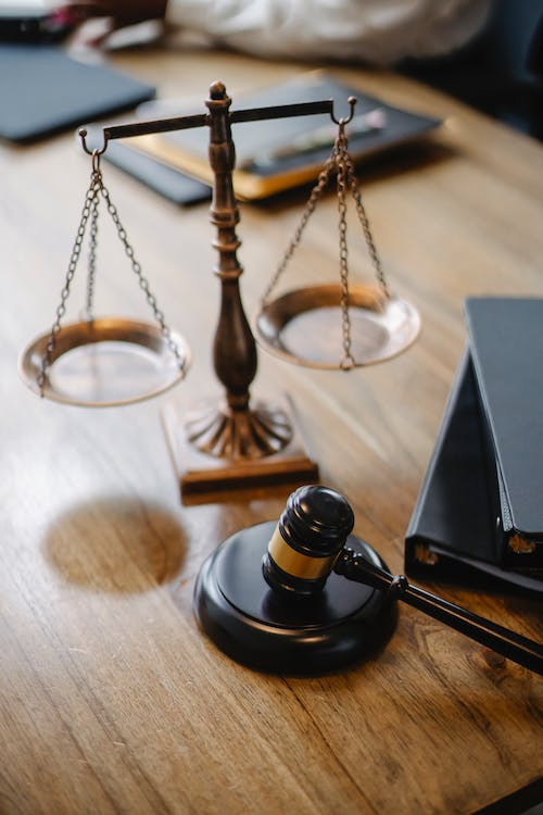 A judge’s desk with a gavel and a balance