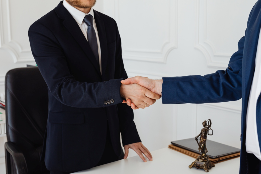 Family lawyer shaking hands with his client 