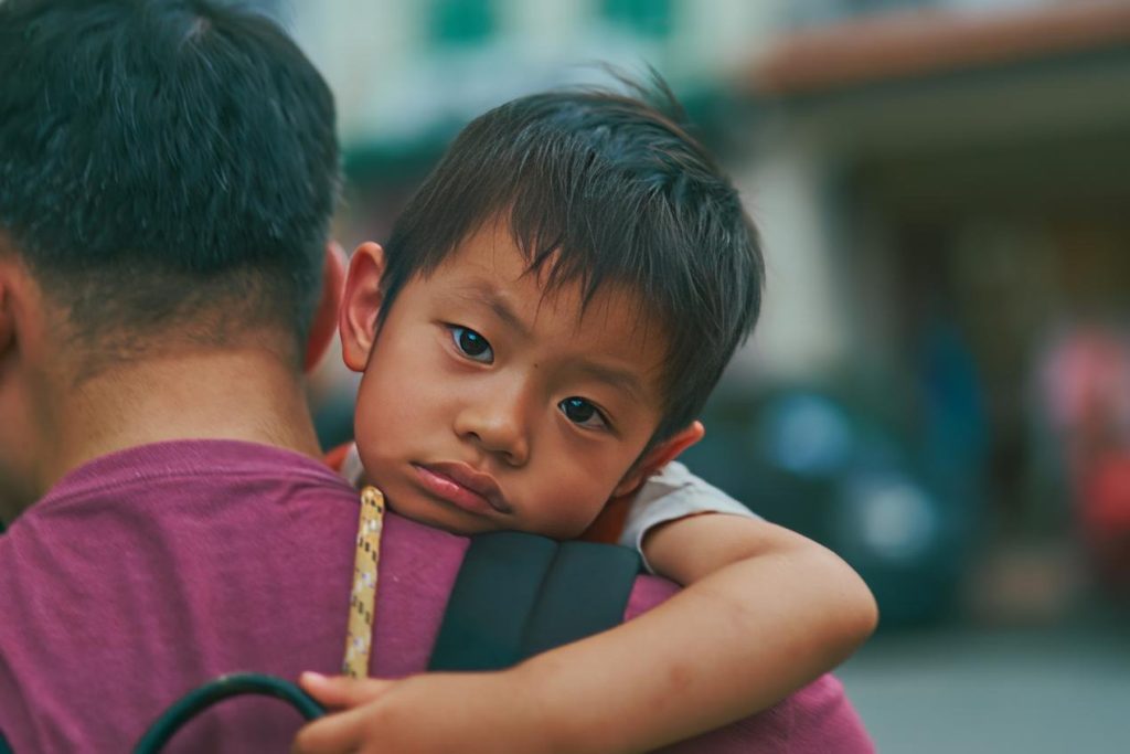 A kid on a man’s shoulder