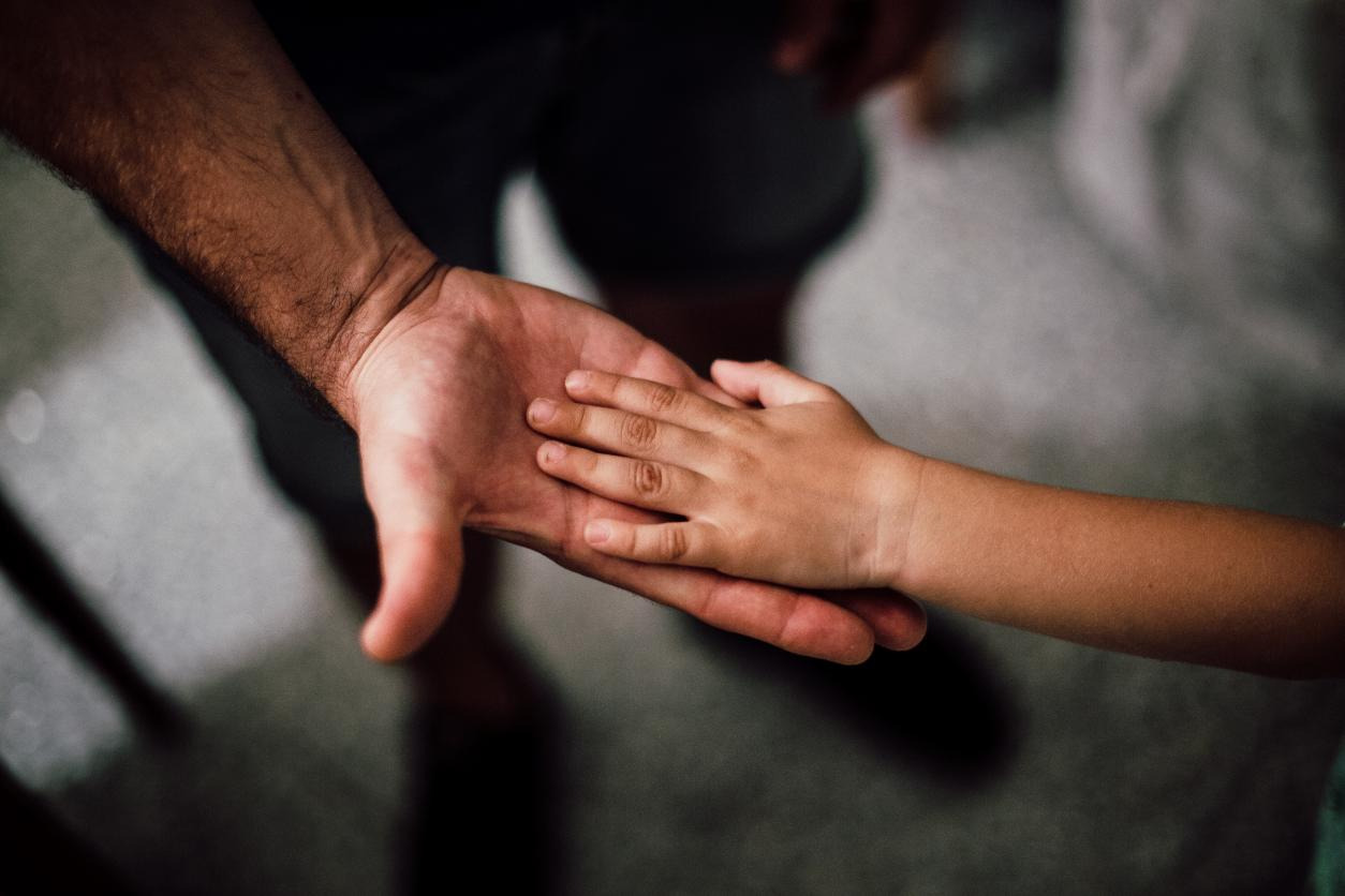 A kid’s hand on an elder’s hand