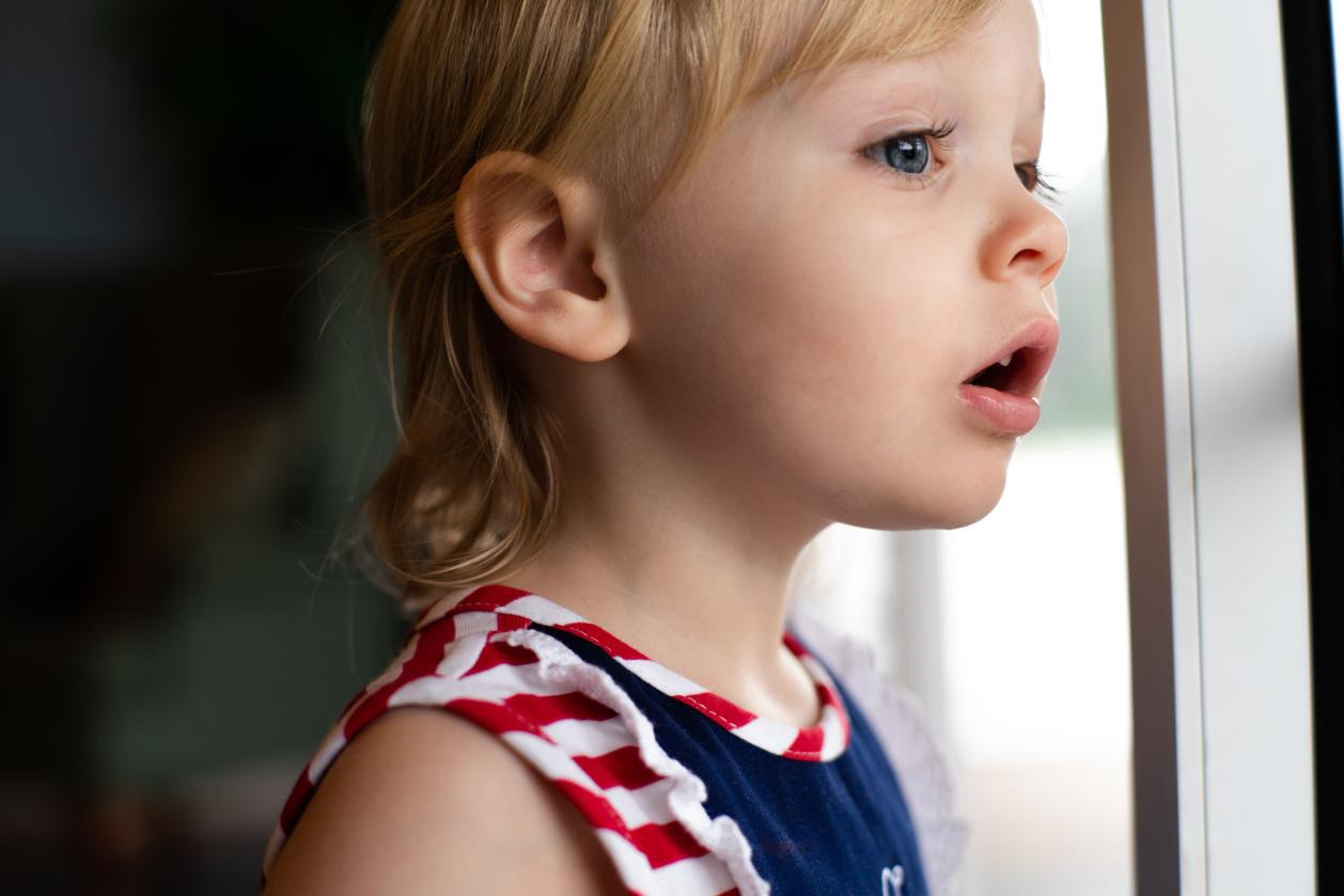 A kid looking out of the window