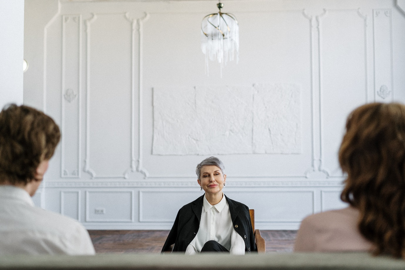 A family law attorney talking to two people 