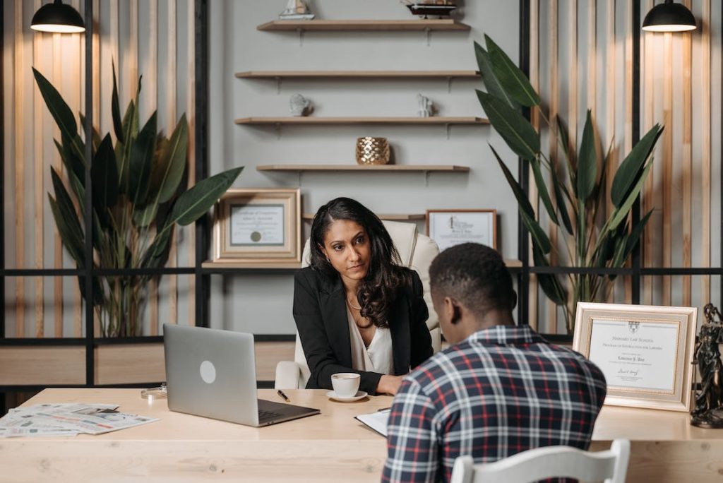 Female attorney discussing documents with a client in an office.