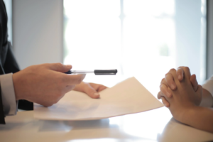 A lawyer handing over a document to a client