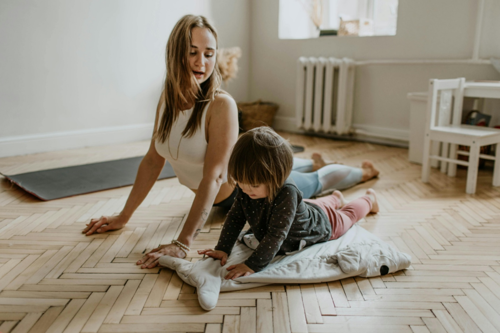 A mother teaching her daughter yoga by https://www.pexels.com/photo/woman-wearing-white-sleeveless-top-3094230/