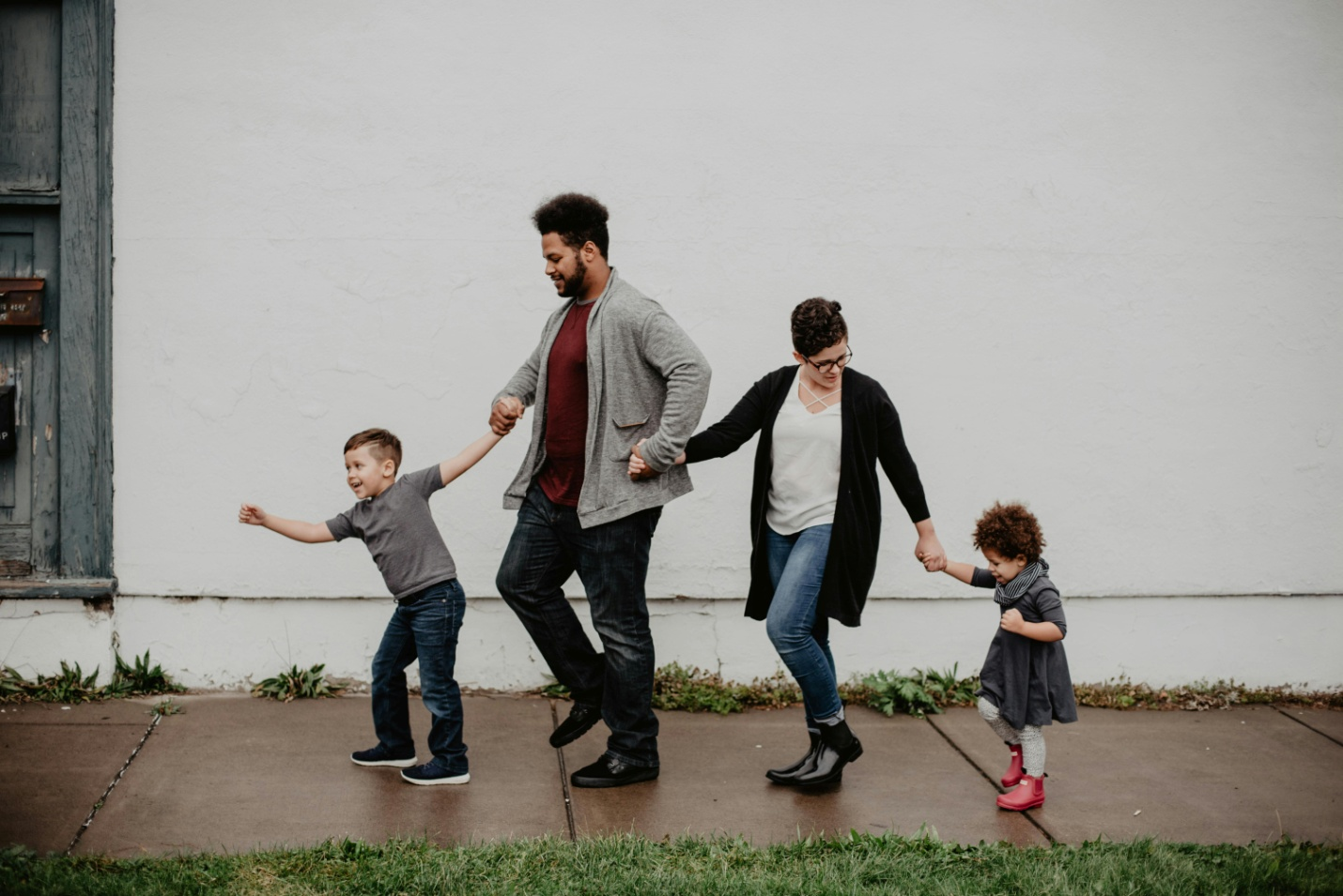 Parents walking with their kids by https://www.pexels.com/photo/family-of-four-walking-at-the-street-2253879/