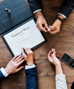 Close-up of hands signing a certificate of divorce