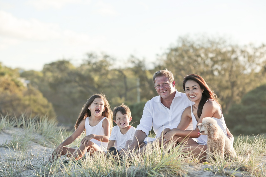 Happy family of four spending time outdoors.