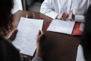 Person reviewing legal documents during a meeting