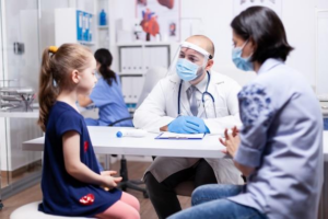 A little girl getting checked by a doctor