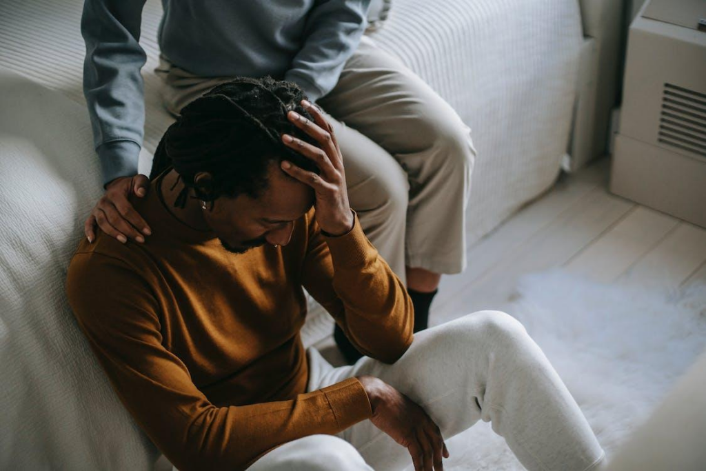 A woman consoling a distressed man