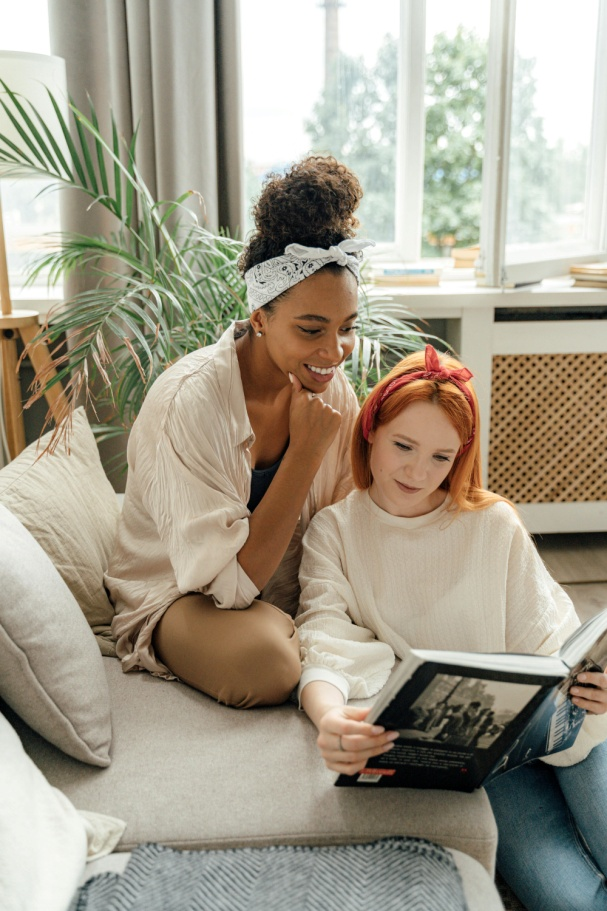 Two women looking at a book