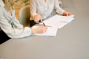 A woman signing divorce papers