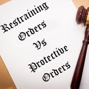 A paper with "Restraining Orders Vs. Protective Orders" written on it