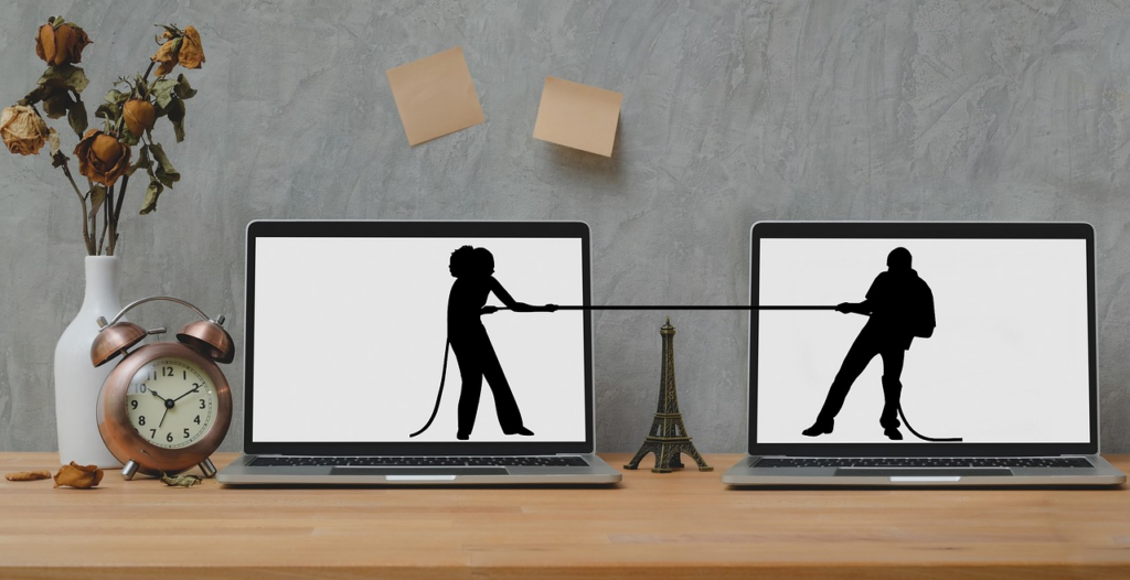 Two images in laptops pulling on a rope