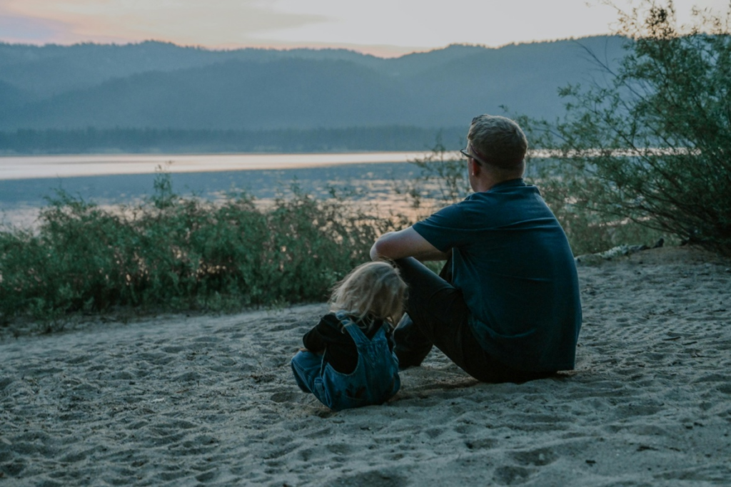 A father enjoying a sunset with his son