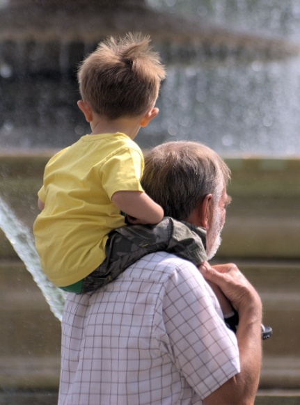 A granddad with a child on his shoulders